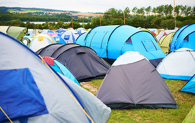 Image showing Tents, field and music festival outdoor for camp event in forest for party celebration, rave weekend on vacation. Shelter, land for crowd concert or dj disco accommodation, park trip in woods nature