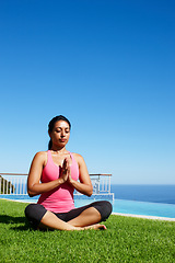 Image showing Meditation, yoga and woman on grass by water for holistic fitness, mindfulness and breathing exercise. Faith, hands in prayer and person by ocean for wellness, health and zen energy outdoors