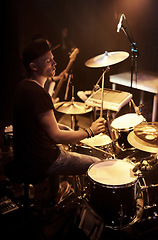 Image showing Music, concert and drummer on stage for band performance with sound equipment or instrument. Party, event or entertainment and musician drumming at festival, show or gig for social celebration