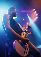 Image showing Music, guitar and lighting with man on stage for concert, show or performance at festival from below. Party, event or entertainment and musician or guitarist playing instrument at musical production