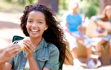 Image showing Kid, eating and portrait with hotdog outdoor in camping chair and relax at barbecue with lunch. Happy, girl and hungry for food from bbq in park, woods or forest on holiday or vacation in summer