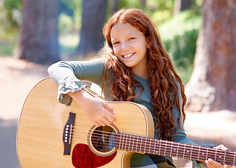 Image showing Camp, portrait and girl child with guitar for entertainment, talent or music in woods or forest. Nature, musician and kid with acoustic string instrument outdoor in park or field on weekend trip.