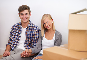 Image showing Couple, moving and new home, portrait with boxes for packing and real estate, happy holding hands and support. Property, investment and people smile with cardboard for relocation, mortgage or rent