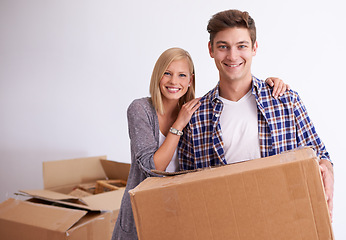 Image showing Couple, moving and new home with box for packing, happy with real estate and support with smile in portrait. Property, investment and people with cardboard package for relocation, mortgage or rent