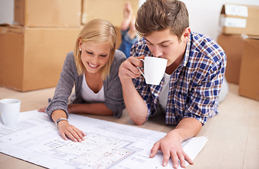 Image showing Couple, floor plan and blueprints with moving boxes for renovation, new home or property investment. Man, woman and happy thinking or development for real estate design for mortgage, buy or coffee