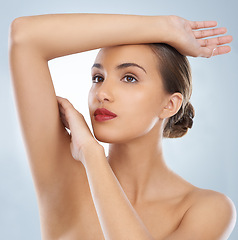 Image showing Confident, makeup and woman in studio with red lipstick for skin shine, cosmetic and face routine. Self care, beauty and female model with facial cosmetology treatment for glow by gray background.