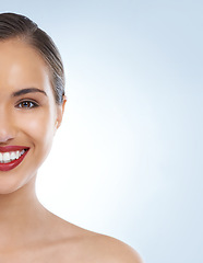 Image showing Happy woman, portrait and face with red lipstick for makeup, beauty or cosmetics on a blue studio background. Young female person or model smile for facial treatment in cosmetology on mockup space