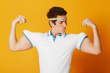 Image showing Tennis, sports and man flexing arms with fitness and workout on yellow background. Person, model and athlete with wellness, goofy or funny with confidence and proud with health, strong or competitive