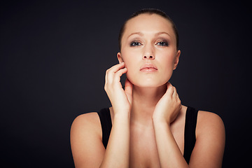 Image showing Makeup, beauty and hands on face of woman in studio for cosmetology, shine or wellness treatment on black background. Cosmetic, glowing skin and female model portrait with confidence and results
