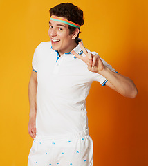 Image showing Portrait, tennis and man with peace sign, smile and confident guy on a yellow studio background. Person, athlete and model with v gesture and symbol with feedback and fitness with wellness or player