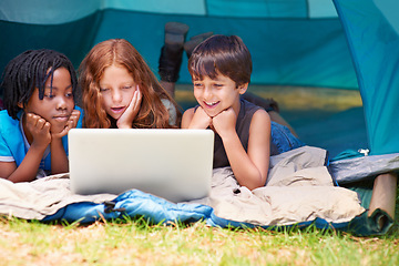 Image showing Children, face and watching with laptop in tent for camping, social media and movie with diversity in nature. Friends, cartoon and group with smile outdoor on grass for travel, relax and holiday fun