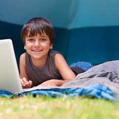 Image showing Child, boy and smile with laptop in tent for camping, social media and online movie with portrait in nature. Person, face and kid or happy outdoor on grass for gaming, vacation relax or holiday fun