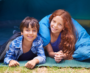 Image showing Happy, camping and portrait of children in sleeping bag for resting, relax and comfortable in tent. Travel gear, smile and kids in sleep sack for adventure on holiday, vacation and weekend outdoors