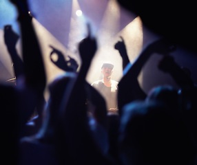 Image showing Concert, audience and dj music with hands from people at rock, band and festival event at a stage with lights. Night show, dance and party with crowd with rave, techno and entertainment at venue