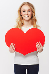 Image showing Young woman, red heart and portrait in studio for happiness, love and valentines day in casual fashion. American model, positive and face with care symbol for affection and gen z by white background