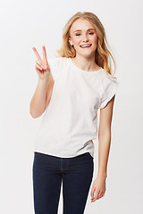 Image showing Young woman, peace sign and portrait in studio for happiness, positive and funky in casual fashion. American model, smile and face with blond hair in trendy jeans, emoji and gen z by white background