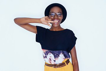 Image showing Portrait, fashion and glasses with happy black woman in studio on white background for style. Model, smile and accessories with confident young hipster person biting finger in trendy clothes outfit