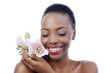 Image showing Black woman, flower and smile for natural beauty, dermatology and skincare for glow and wellness on white background. Nature, skin and sustainable cosmetics, face with shine and orchid in a studio