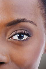 Image showing Eyeshadow, makeup and black woman closeup with beauty and skincare on half of face. Eye, portrait and African model with healthy glow and shine on skin from dermatology, cosmetics or foundation