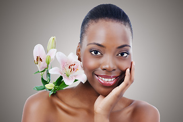 Image showing Flower, skin and black woman in portrait, beauty and dermatology with wellness in studio on grey background. Healthy glow, eco friendly skincare and orchid for treatment, face and natural cosmetics