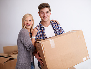 Image showing Couple, moving and new house with box for packing, happy with real estate and support in portrait and smile. Property, investment and people with cardboard package for relocation, mortgage or rent