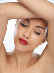 Image showing Woman, face and beauty with red lipstick or makeup in cosmetics on a blue studio background. Closeup of young female person or model in relax or satisfaction for cosmetology or facial spa treatment