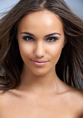 Image showing Happy woman, portrait and hair in natural beauty, skincare or cosmetics on a gray studio background. Face of female person, brunette or model smile in satisfaction for facial treatment or haircare