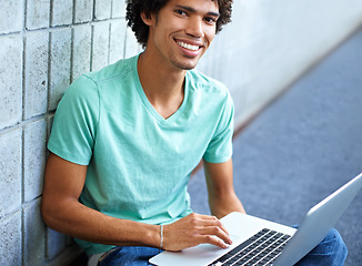 Image showing Student, black man in portrait and laptop for education, e learning and typing essay, research or planning in college. Young smart person with computer for university, FAQ or online studying on floor