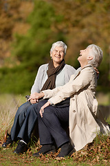 Image showing Senior friends, laughing or conversation in nature for travel, together or bonding on retirement in outdoor. Elderly women, smile or communication on vacation in countryside, care or comic on rock