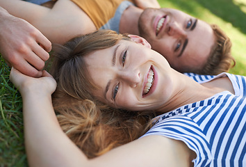 Image showing Lawn, love and portrait of happy couple relax for summer sunshine, wellness or weekend break for outdoor leisure. Smile, care and face of boyfriend, girlfriend or people lying on grass pitch together