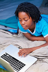 Image showing Child, relax and play with laptop in tent with cartoon, movie or online games on holiday or vacation. Kid, smile and watch video on streaming, website or search on internet for computer elearning