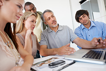 Image showing Men, women and laptop in meeting for creative collaboration at magazine agency for problem solving, project or proposal. Group, diversity and brainstorming for company ideas, campaign or planning