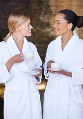 Image showing Spa, friends and women drinking coffee for health, wellness and luxury skincare treatment for body. Girls, tea cup and happy people in salon together for beauty in bathrobe, relax and diversity