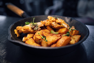 Image showing Fried potato wedges with schnitzel