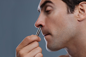 Image showing Nose hair, cleaning and man with tweezers and pain from plucking in studio background or mockup. Beauty, epilation and person with facial grooming routine and treatment for self care with tools