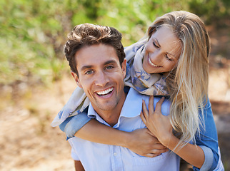 Image showing Couple, portrait and happy in nature with piggyback in relationship for holiday, vacation or travel. Romance, man and woman with smile outdoor in forest with hug for bonding, love and relax in woods