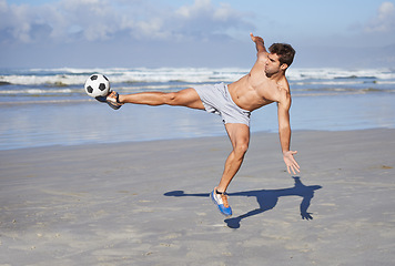 Image showing Man, beach and kicking soccer ball for game, sports or exercise in outdoor hobby, training or practice. Young muscular male person or football player in match or cardio workout by ocean coast or sea