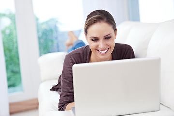 Image showing Woman, laptop and relax on sofa for remote work, streaming movies and update blog post at home. Happy freelancer, computer and download subscription, online shopping and search news on social media