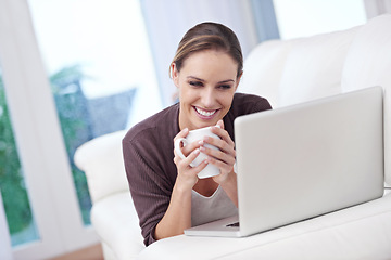 Image showing Coffee, happy woman and laptop on a sofa for streaming movie, film or online video home. Face, smile and female person relax in a living room with pc, tea or social media, subscription or service