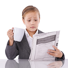 Image showing Shocked child, reading newspaper or studio with confused for business, coffee or surprise by daily headlines. Little girl, suit or thinking by mug as pretend professional or funny by white background