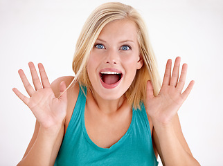 Image showing Surprise, happy and portrait of woman on a white background with good news, deal and sale. Excited, emoji reaction and face of person with hands up for announcement, information and shocked in studio