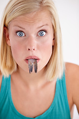 Image showing Surprise, woman and portrait eating fish with shock on white background of studio. Wow, crazy and person on diet with fear of weird seafood, cuisine and disgust in mouth for gross, tail and food