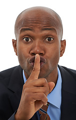 Image showing Black man, portrait and hand for business secret, gossip or confidential information on a white studio background. Face of African businessman with finger on lips in silence, whisper or quiet gesture