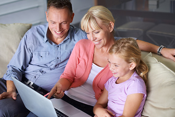 Image showing Family, laptop and parents with daughter on sofa in living room of home for entertainment streaming. Love, smile or happy with mother, father and girl children watching video on computer in apartment