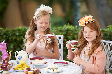 Image showing Tea, party and girl children are playing with fine china, celebration and fun in backyard. Relax, spring with cake or dessert, beverage or drink with friends outdoor in garden for game or birthday