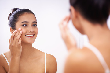 Image showing Happy woman, face and cream in mirror for beauty, cosmetics or makeup in bathroom at home. Female person or model smile applying lotion or moisturizer for facial, skincare or treatment in reflection