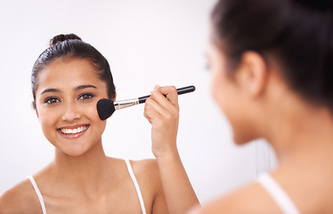 Image showing Happy woman, portrait and makeup brush in mirror for cosmetics, grooming or beauty in bathroom at home. Female person smile or applying foundation, blush or contour for facial treatment in reflection