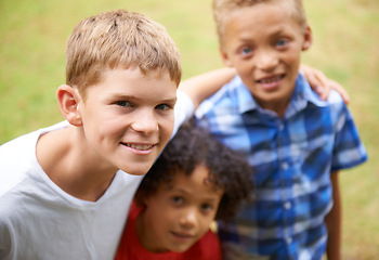 Image showing Boy, friends and portrait or happy outdoor in summer with confidence, pride or diversity in nature. Children, face or smile on grass field with embrace for friendship, care and support on playground