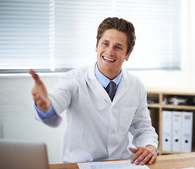 Image showing Handshake, smile and man doctor in office for greeting hello at a medical consultation at clinic. Happy, professional and young male healthcare worker with shaking hand gesture in a medicare hospital