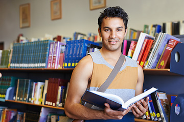 Image showing Reading book, portrait or happy man in library at university, college or school campus for education. Bookshelf, learning or male student with scholarship studying knowledge, research or information